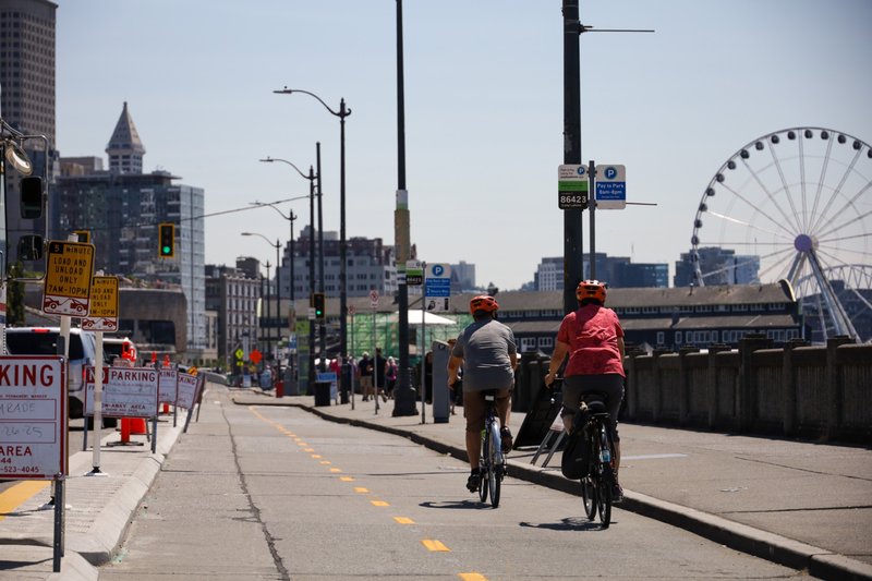Cyclists Riding Downtown via Alaskan Way Protected Way Bike Lane